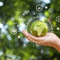 Hand of human holding green earth with the icon of Environment for ESG, co2, and net zero. World sustainable environment concept.