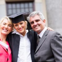 Portrait of Mom, Dad, and Daughter. Daughter graduated.