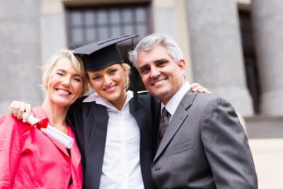Portrait of Mom, Dad, and Daughter. Daughter graduated. 