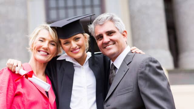 Portrait of Mom, Dad, and Daughter. Daughter graduated.